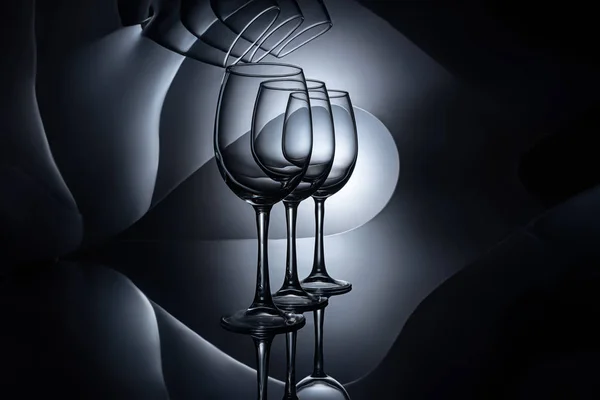 Reihe auf leeren Weingläsern, dunkles Studio — Stockfoto