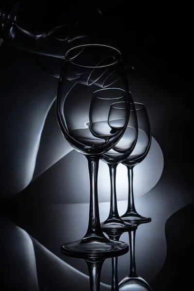 Row on elegant wine glasses, dark studio shot — Stock Photo