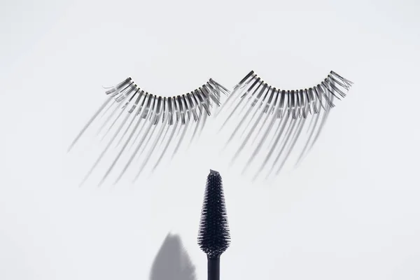 Set of eyelashes with brush on white background — Stock Photo