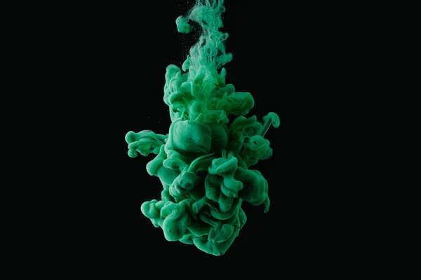 Abstract flowing green paint on black background — Stock Photo