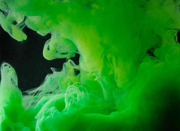 Close-up view of bright green abstract ink on black background — Stock Photo