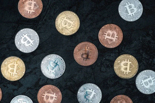 Top view of arranged various bitcoins on dark marble tabletop — Stock Photo