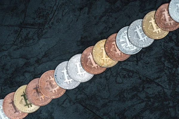 Top view of arranged bitcoins on dark marble tabletop — Stock Photo