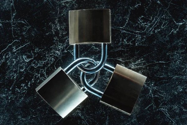 Top view of metal locks on dark marble tabletop — Stock Photo