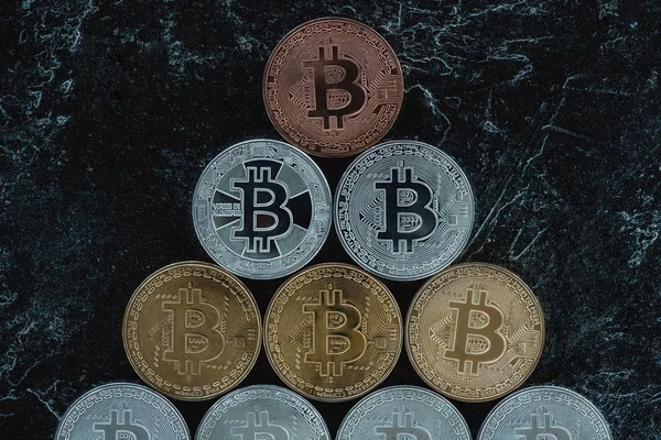 Top view of arranged bitcoins on marble tabletop — Stock Photo