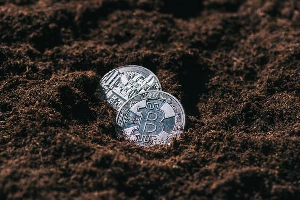 Close up view of silver bitcoins in ground — Stock Photo