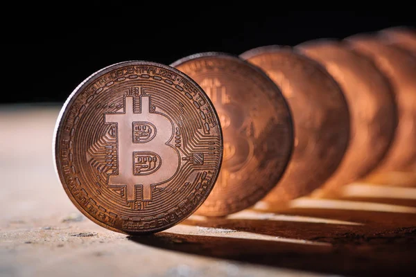 Close up view of arranged bitcoins on black backdrop — Stock Photo