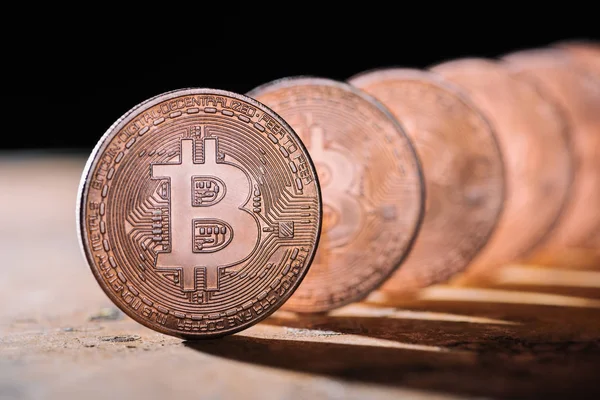 Close up view of arranged bitcoins on black backdrop — Stock Photo