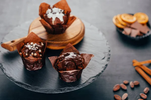 Sweet chocolate muffins on dark slate board — Stock Photo