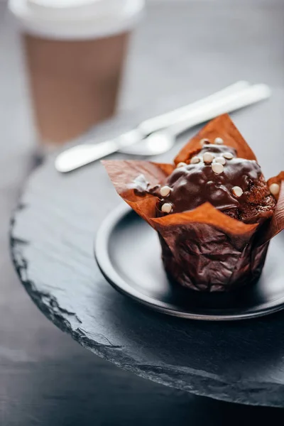 Sweet chocolate cupcake on slate board background — Stock Photo