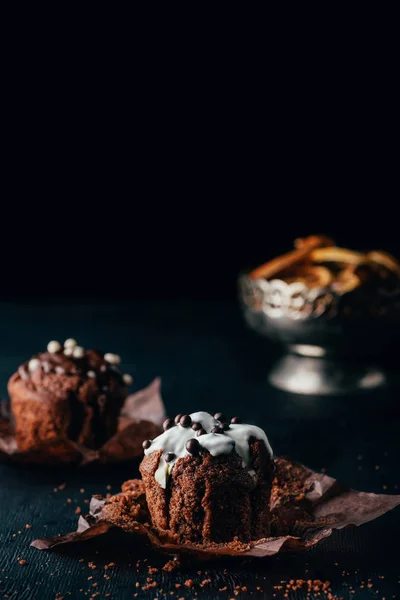 Delicious muffins with glaze on dark background — Stock Photo