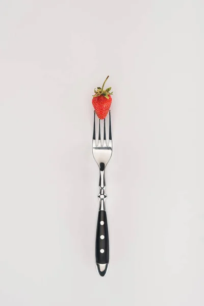 Raw strawberry on a fork isolated on white background — Stock Photo