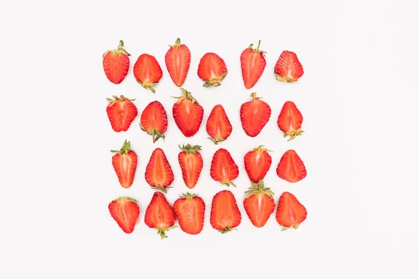 Top view of fresh cut strawberries in rows isolated on white background — Stock Photo