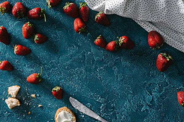 Raw strawberries on blue table with cooking ingredients — Stock Photo