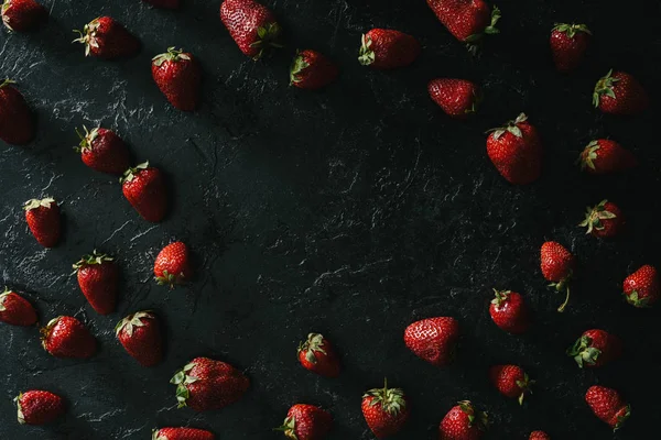 Frame of raw juicy strawberries on dark background — Stock Photo