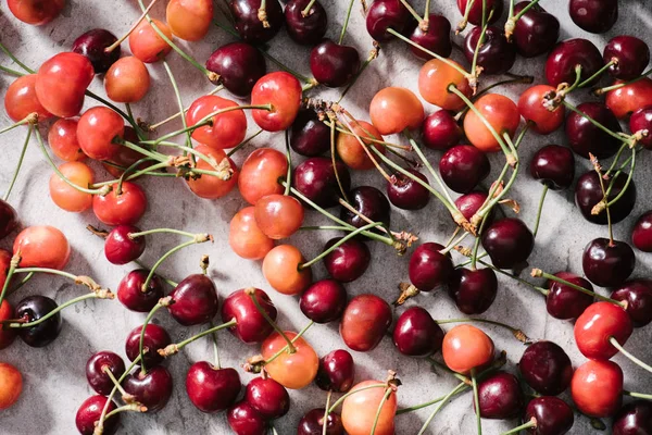 Top view of fresh ripe organic cherries on marble surface — Stock Photo