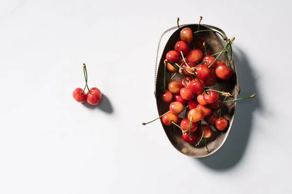 Top view of tasty healthy organic cherries in vintage bowl on white — Stock Photo