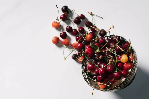 Top view of fresh ripe sweet cherries in vintage bowl on white — Stock Photo