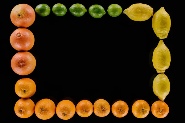 Top view of frame made of ripe various citrus fruits isolated on black — Stock Photo