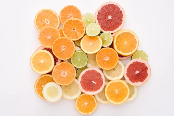 Top view of heap of various citrus fruits slices isolated on white surface — Stock Photo