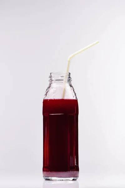 Glass bottle of fresh blueberry juice on white — Stock Photo