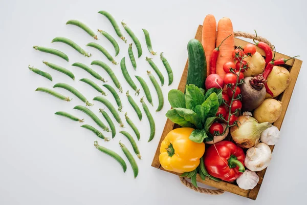 Ansicht der Schachtel mit frischem reifem Gemüse und grünen Erbsen isoliert auf weiß — Stockfoto