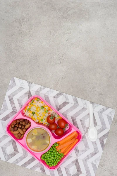 Top view of tray with kids lunch for school on napkin on marble table — Stock Photo