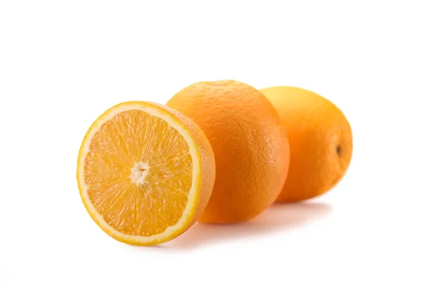 Close up view of wholesome oranges with cut piece isolated on white — Stock Photo