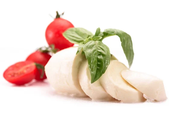 Close up view of cherry tomatoes, mozzarella cheese and basil leaves isolated on white — Stock Photo