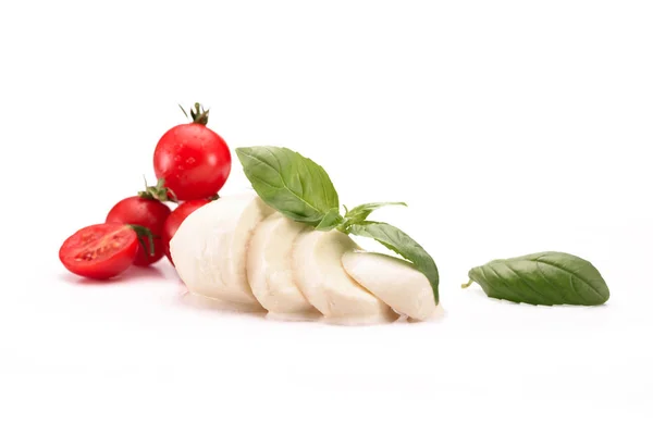 Vista de cerca de tomates cherry, queso mozzarella y hojas de albahaca aisladas en blanco - foto de stock