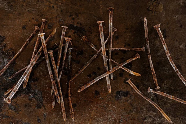 Flat lay with vintage nails arranged on sharped rusty surface — Stock Photo