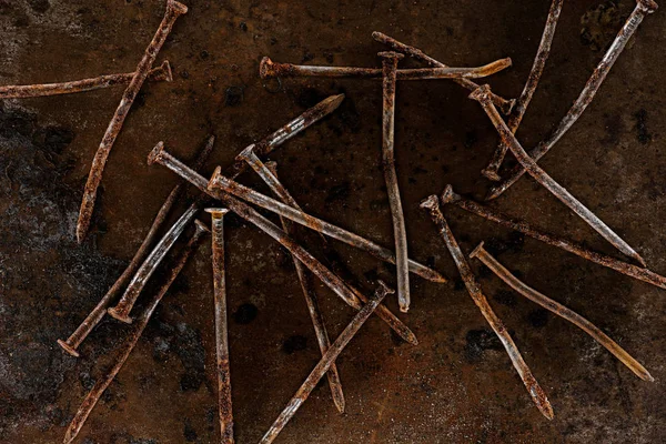 Flat lay with vintage nails arranged on sharped rusty surface — Stock Photo