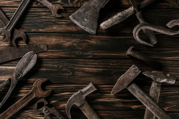 Flat lay with assortment of vintage rusty carpentry tools on wooden surface — Stock Photo