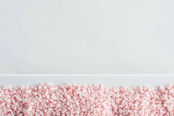 Top view of pink sea salt on white background — Stock Photo