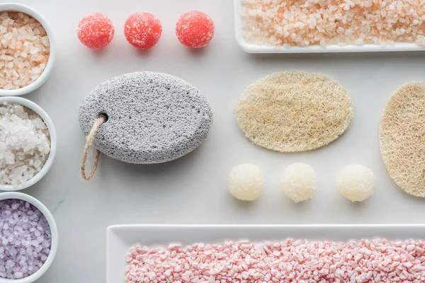 Top view of various sea salt, sponges and handmade soap on white — Stock Photo