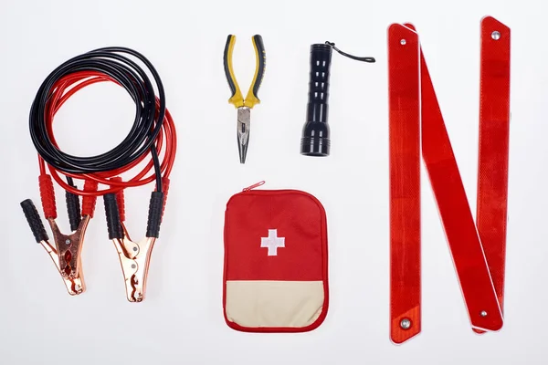 Flat lay with first aid kit and automotive accessories isolated on white — Stock Photo