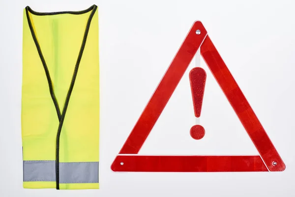 Top view of warning triangle and reflective vest isolated on white — Stock Photo