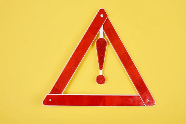 Top view of warning triangle road sign isolated on yellow — Stock Photo