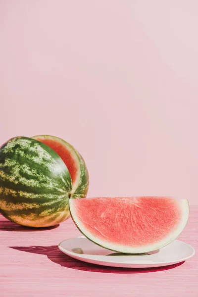 Nahaufnahme einer Scheibe Wassermelone auf Teller auf rosa Hintergrund — Stockfoto