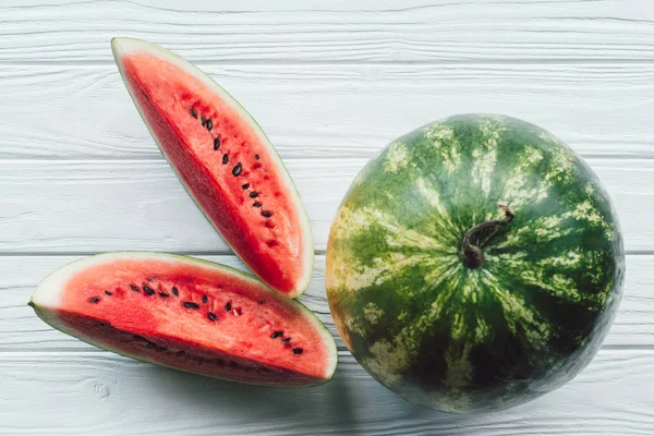 Top view of juice watermelon on white wooden surface — Stock Photo