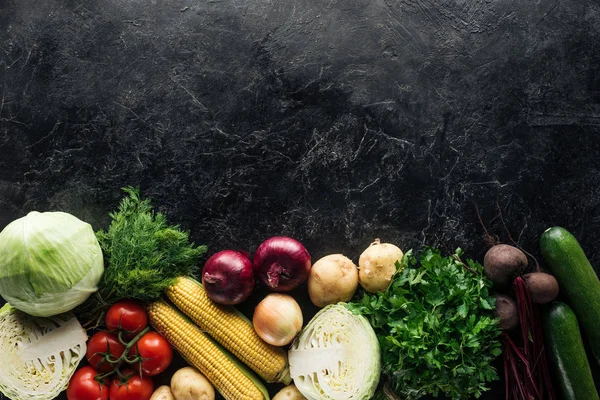 Flat lay with food composition of autumn harvest on black marble surface — Stock Photo