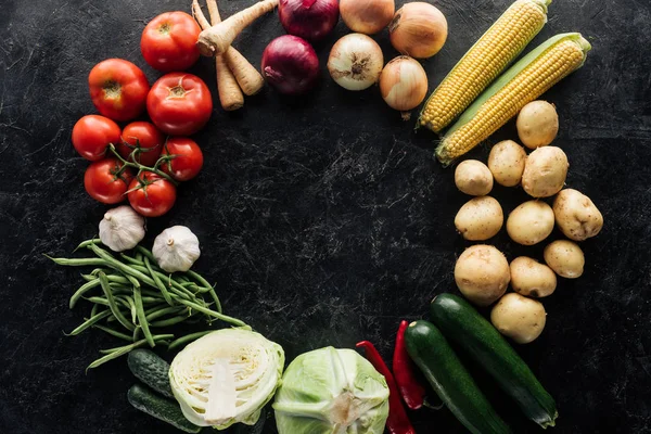 Flat lay with food composition of autumn harvest on black marble surface — Stock Photo