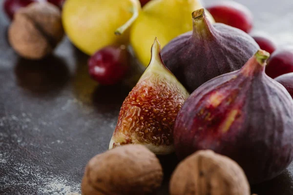 Close up view of figs, pears and hazelnuts arranged on tabletop — Stock Photo