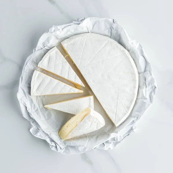 Top view of camembert cheese on white marble tabletop — Stock Photo