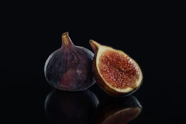 Close up view of fresh figs on black background — Stock Photo