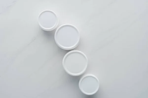 Vue du dessus des bouteilles de crème sur surface blanche, concept beauté — Photo de stock