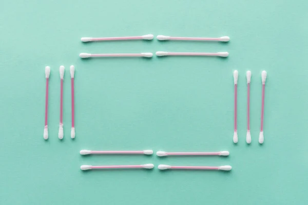 Top view of cotton swabs isolated on green, beauty concept — Stock Photo