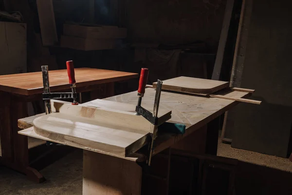 Nahaufnahme des Tischlerarbeitsplatzes mit Holzbohlen in der Werkstatt — Stockfoto