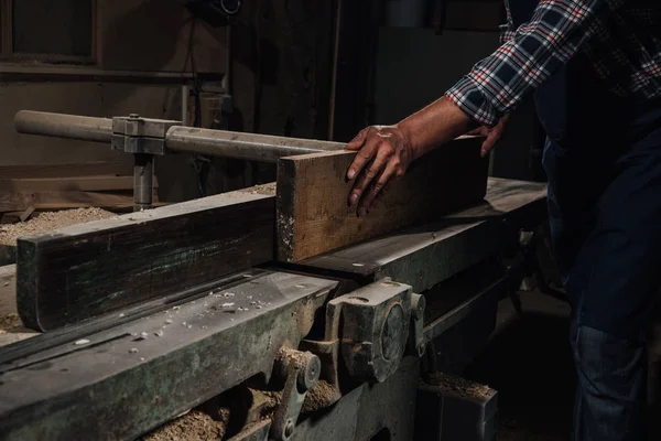 Cropped shot of carpenter working with wood at workshop — Stock Photo