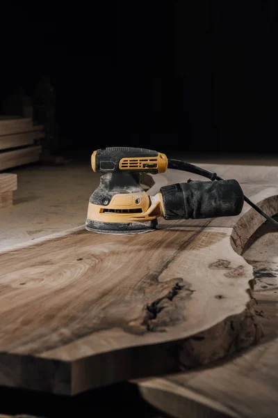 Close up view of electric plane and wooden planks at workshop — Stock Photo